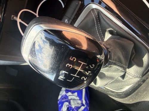 Close-up of a six-speed manual gear stick.